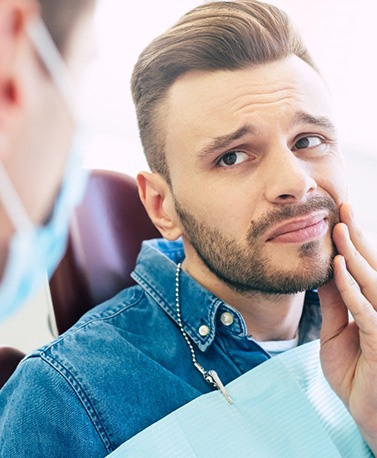 Patient with toothache looking at dentist