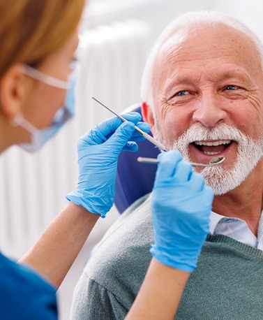 Man smiles at dentist