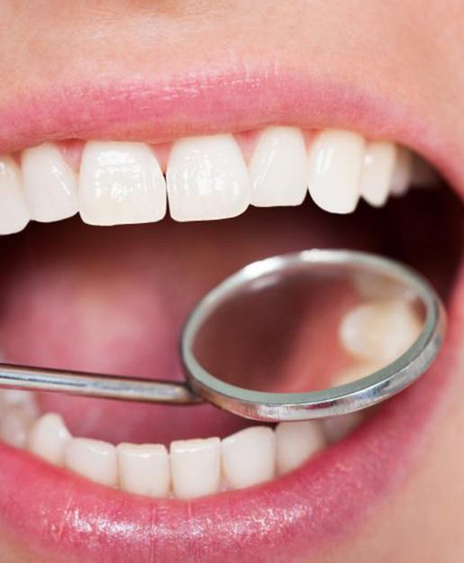 Teeth examined with dental mirror