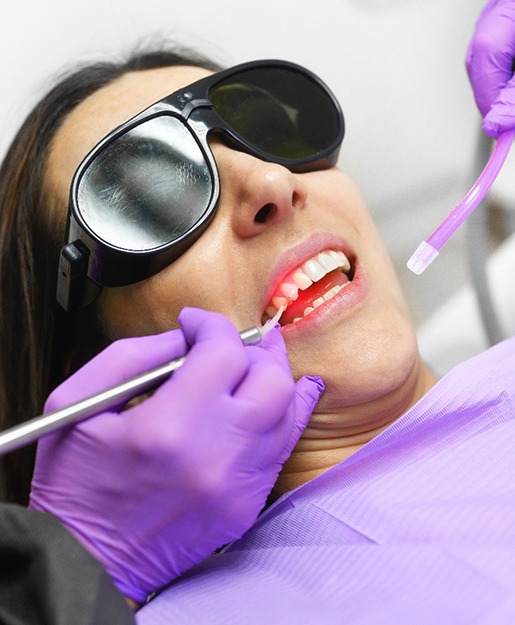 A woman getting an cosmetic gum lift with a soft tissue laser