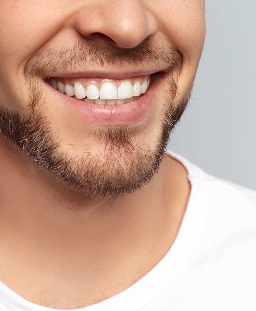 a dentist showing a patient a model of a mouth