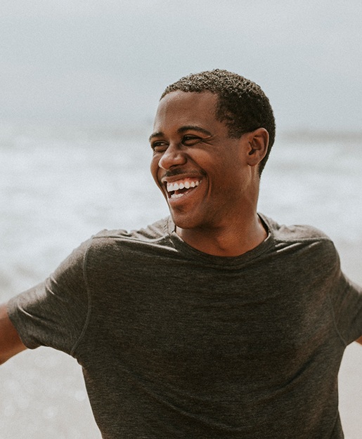 a front desk dental assistant showing a patient forms on a tablet