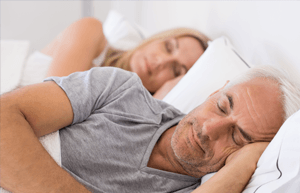 couple sleeping in white room