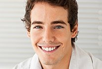 Close-up of man in collared shirt smiling