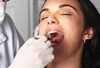 Woman receiving dental treatment with sedation dentistry