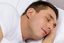 Man lying in bed and sleeping