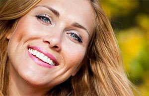 Close-up of a woman smiling outside