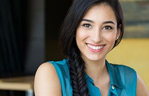 Woman sitting and smiling inside
