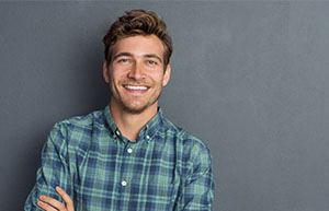 Man in button-up shirt smiling