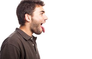 side view of man sticking tongue out