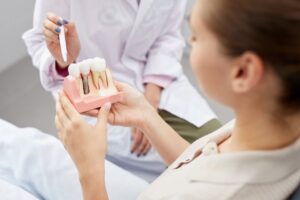 Woman learning more about dental implants at consultation