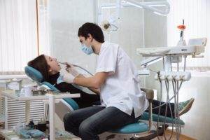 Find the right dentist in Tyler assisting a couple in a dental chair.