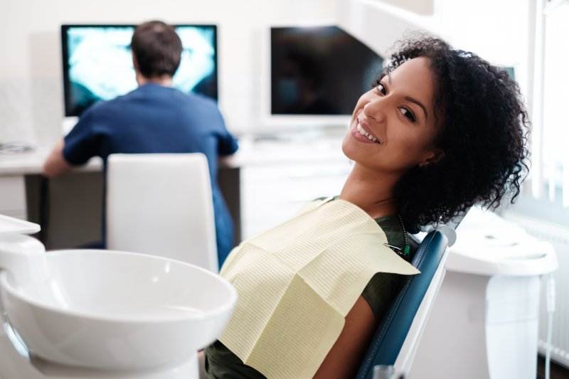 Woman smiling while overcoming her dental anxiety in Bullard