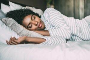 Woman comfortably sleeping on her side