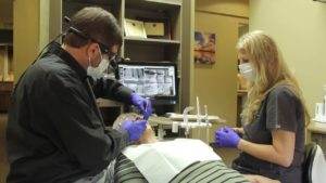 A woman and a man with sleep apnea in a dentist's office.