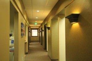 About Us: A hallway in a medical office.