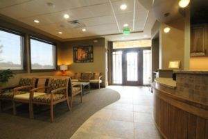 An About Us section featuring a reception area in a dental office.