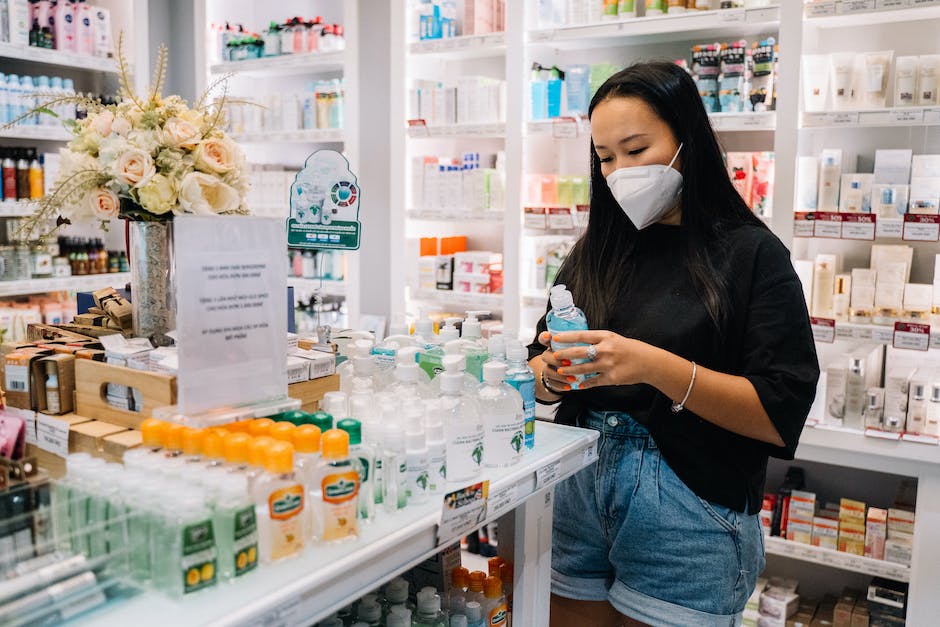 A woman wearing a face mask in a pharmacy.