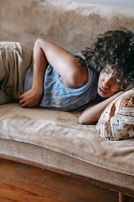 A woman laying on a couch with a pillow.